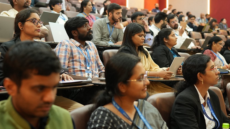 Participants listening to a session in an auditorium