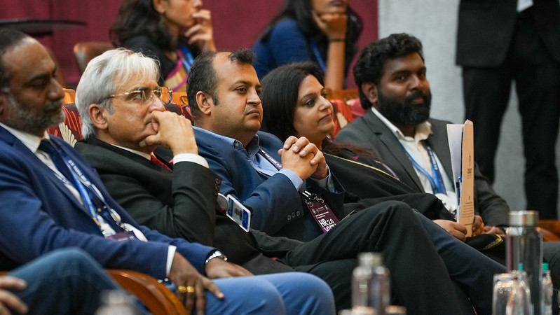 Attendees seated in an auditorium during a session