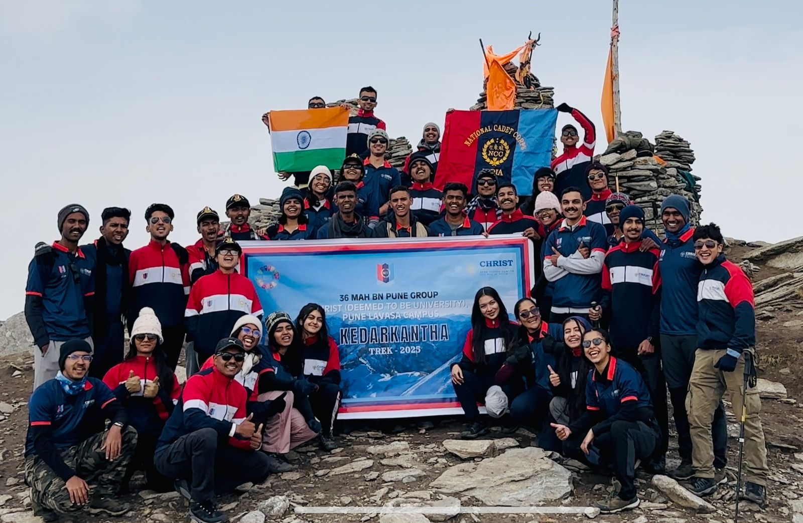 Cadets at the Kedarkantha summit with the national flag and unit banner