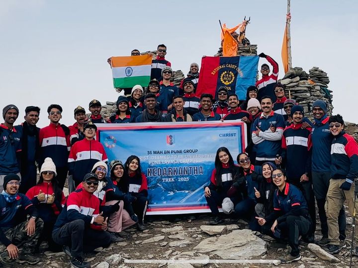 Cadets at the Kedarkantha summit with the national flag and unit banner, CHRIST Pune Lavasa Campus
