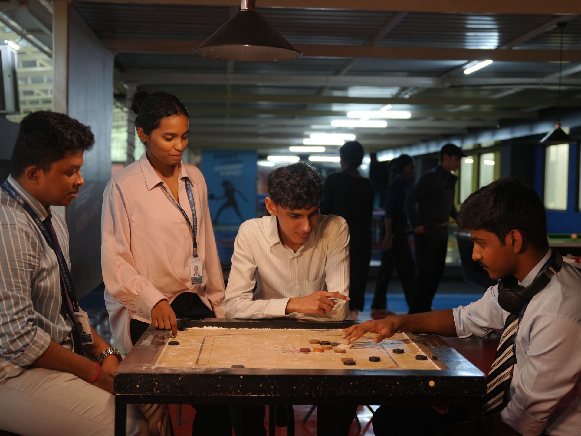 Students playing carrom between classes at CHRIST Lavasa