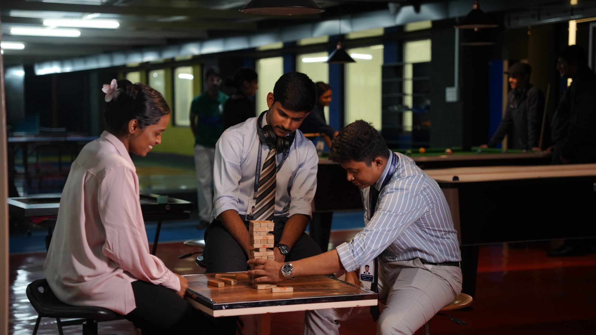 Students playing carrom and table games at the indoor recreation room, CHRIST Lavasa